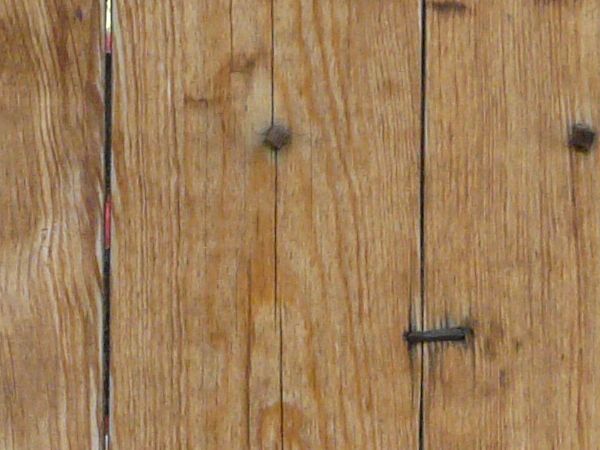 New wooden planks set vertically with bent nails.
